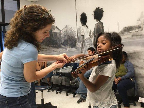 A teacher correcting form for a violin student